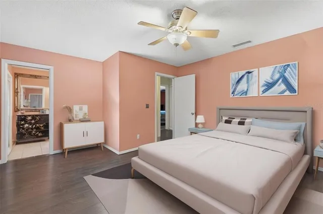 a bedroom with a large bed and a chandelier