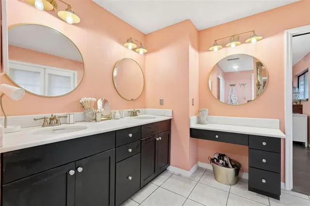 a bathroom with a double vanity sink and a mirror