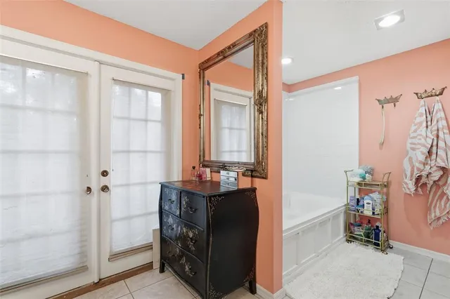 a en suite bathroom with a tub shower and window