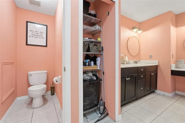 a bathroom with a toilet sink vanity and mirror