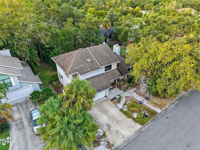 an aerial view of a house with yard swimming pool and outdoor seating