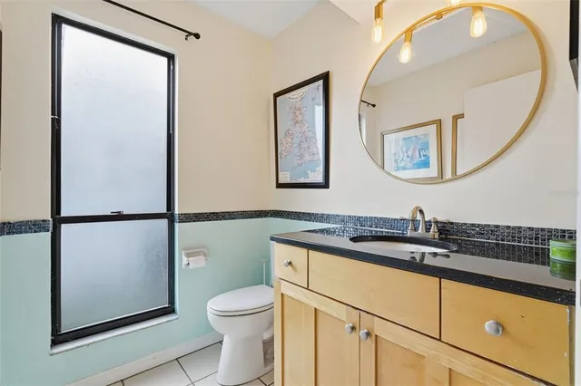 a bathroom with a toilet a sink and a mirror