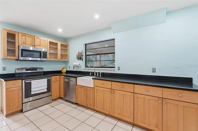 a kitchen with stainless steel appliances granite countertop a sink and a stove
