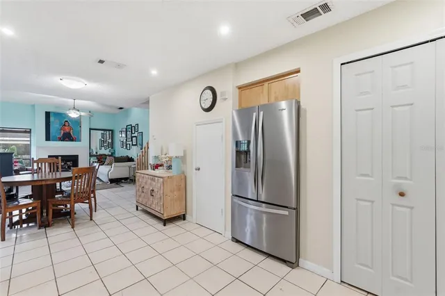 a kitchen with a refrigerator and table