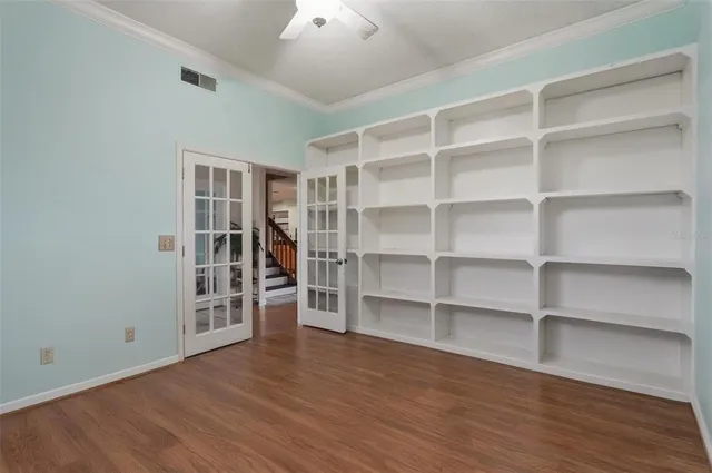 a view of wooden floor and windows in a room