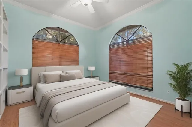 a bedroom with a bed and a painting on the wall