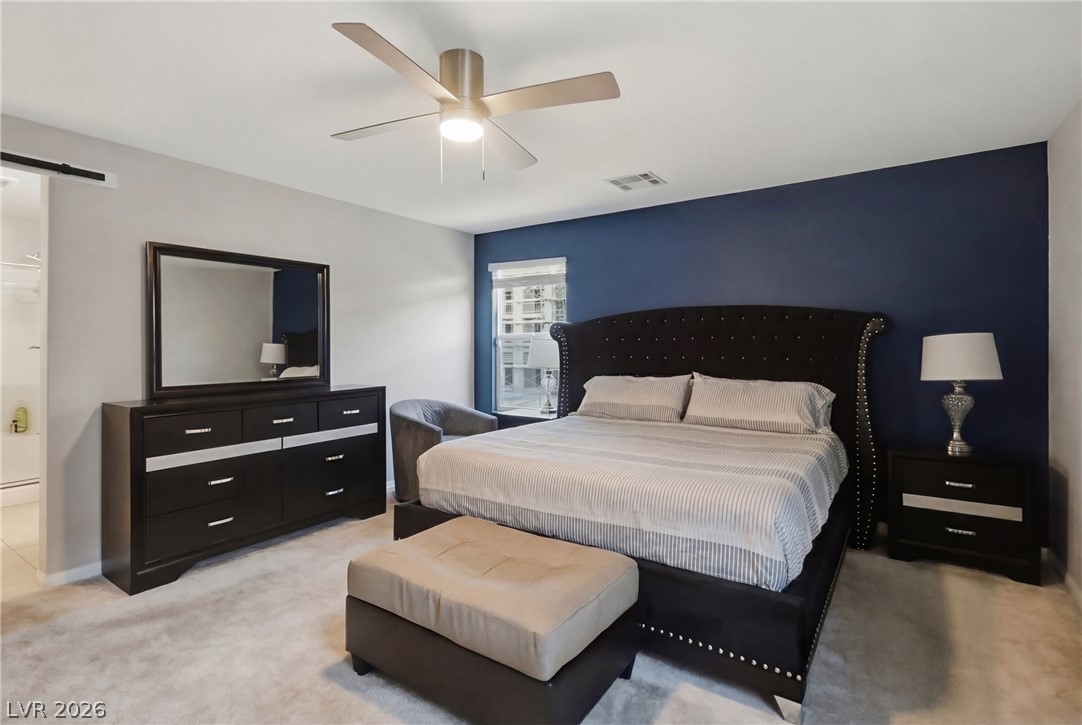 1921 Miller Ridge Avenue North Las Vegas, NV 89031 - Photo 17 of 26 This spacious primary bedroom offers comfort and ample room for relaxation.