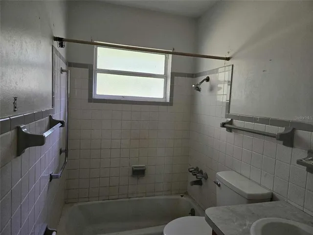 a bathroom with a toilet and shower