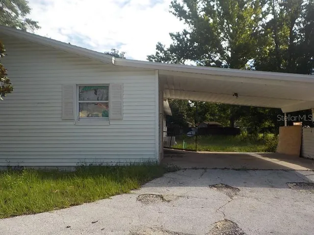 a view of a back yard of the house and a chair