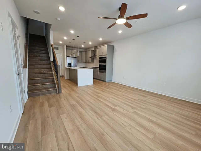 a view of kitchen with sink and refrigerator