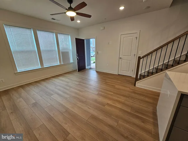 a view of an entryway with wooden floor