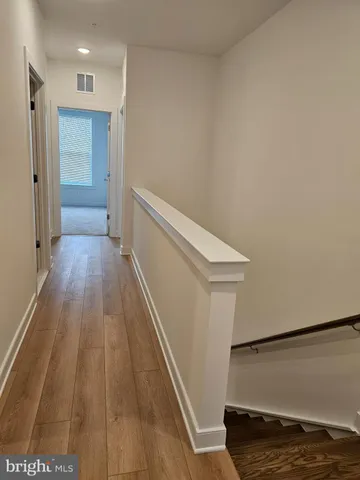a view of hallway with wooden floor