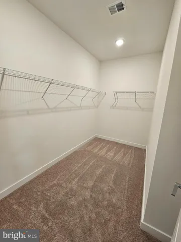 a view of storage and utility room with racks on the wall