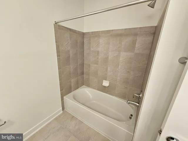 a white toilet sitting next to a white sink and vanity