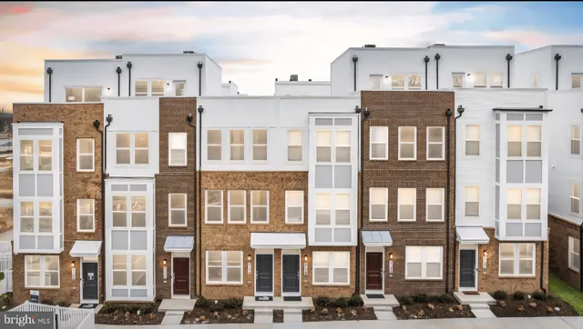 a view of a patio with couches table and chairs under an umbrella