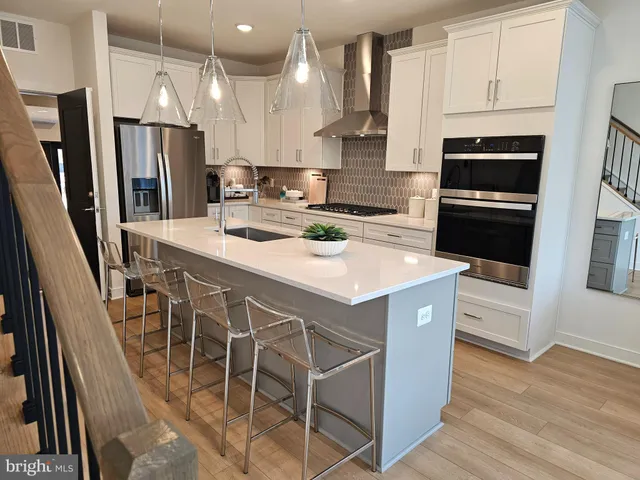a kitchen with a sink a microwave a refrigerator and cabinets