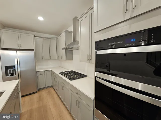 a kitchen with stainless steel appliances kitchen island a stove and a refrigerator