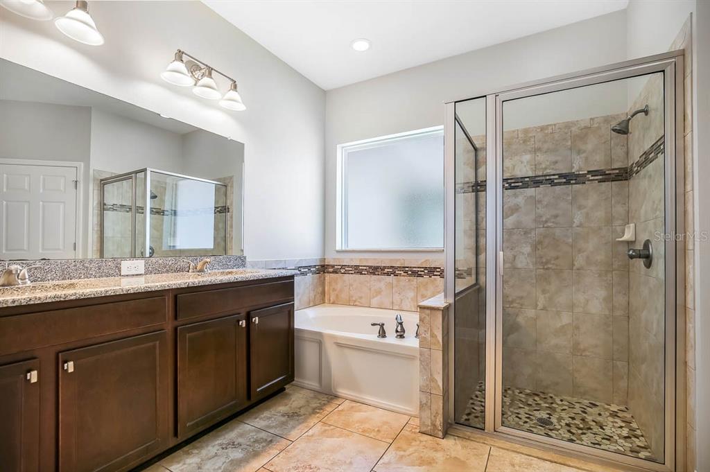 5310 Match Point Place Lithia, FL 33547 - Photo 13 of 33 a bathroom with a double vanity sink mirror double and shower
