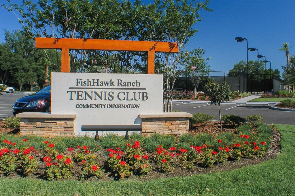 5310 Match Point Place Lithia, FL 33547 - Photo 24 of 33 a view of a sign board with flower plants and wooden fence