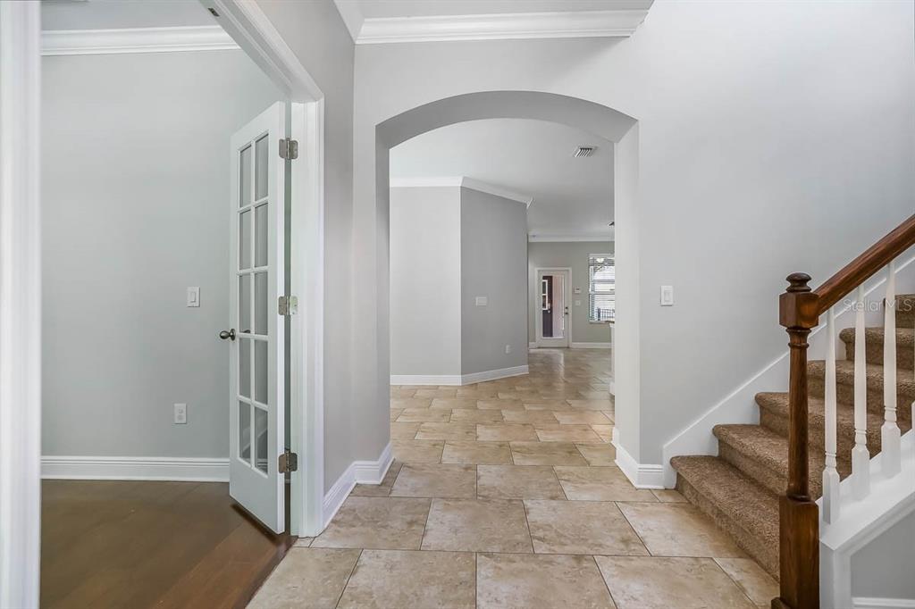 5310 Match Point Place Lithia, FL 33547 - Photo 3 of 33 a view of a hallway with wooden floor and staircase