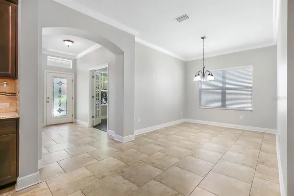 a kitchen with stainless steel appliances a sink a counter top space cabinets and a window