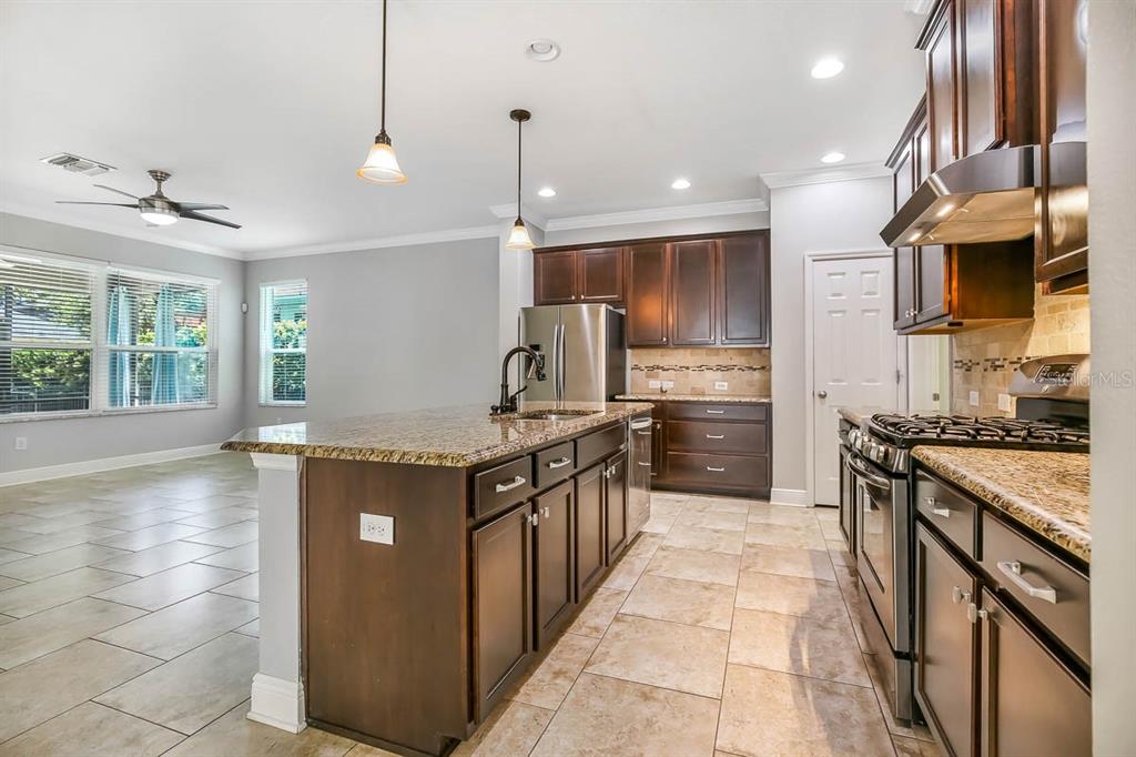 5310 Match Point Place Lithia, FL 33547 - Photo 7 of 33 a kitchen with stainless steel appliances granite countertop a stove a sink and a refrigerator
