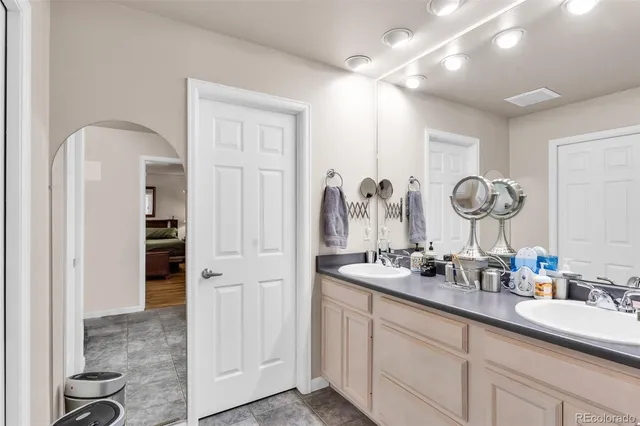 a bathroom with a double vanity sink and a mirror