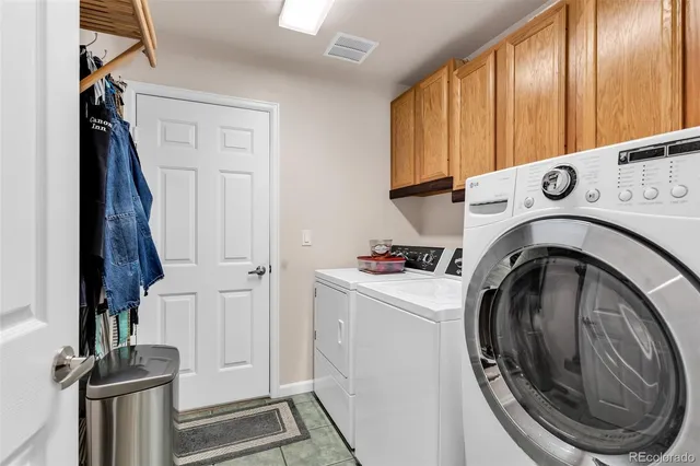a view of a storage and utility room with washer and dryer