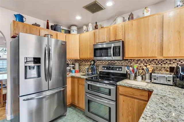 a kitchen with stainless steel appliances a refrigerator a stove a microwave a sink and dishwasher