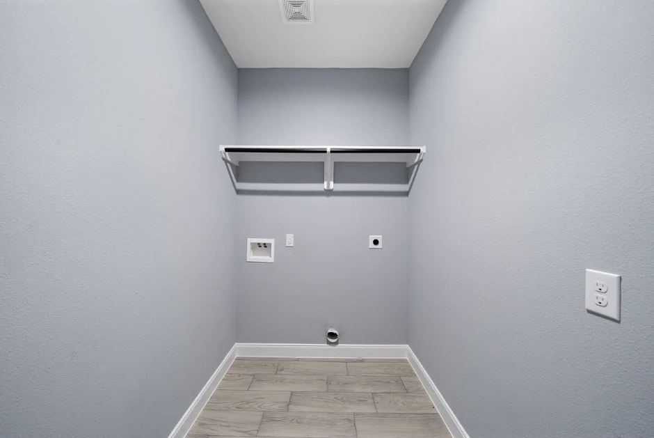 5222 Bataan Road Houston, TX 77033 - Photo 9 of 22 Functional laundry area with built-in storage space, combining convenience with simplicity.