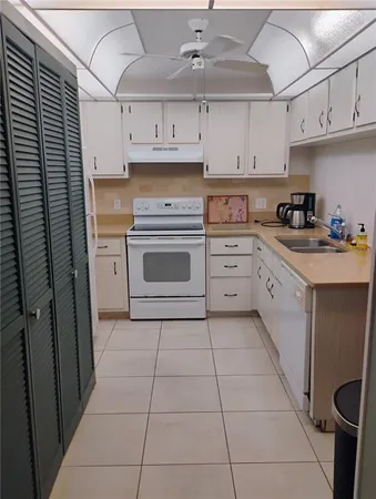 a kitchen with cabinets and appliances