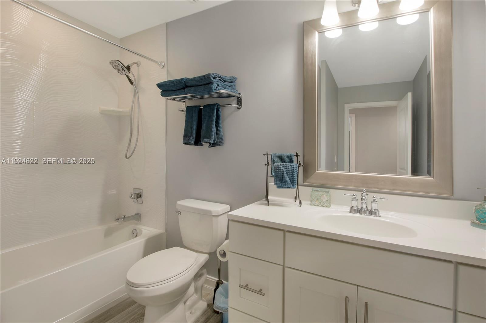 9155 Southeast Athena Street Hobe Sound, FL 33455 - Photo 12 of 25 a bathroom with a sink toilet a shower and bathtub