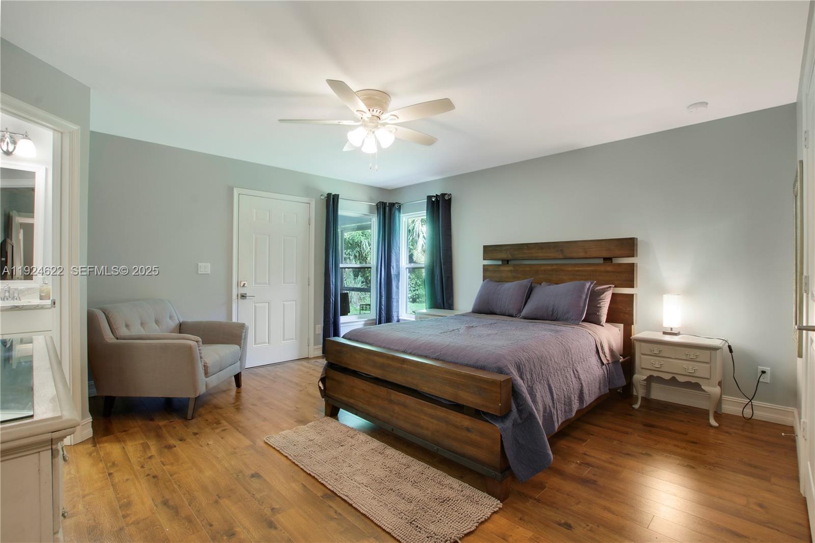 9155 Southeast Athena Street Hobe Sound, FL 33455 - Photo 14 of 25 a bedroom with a bed and a couch