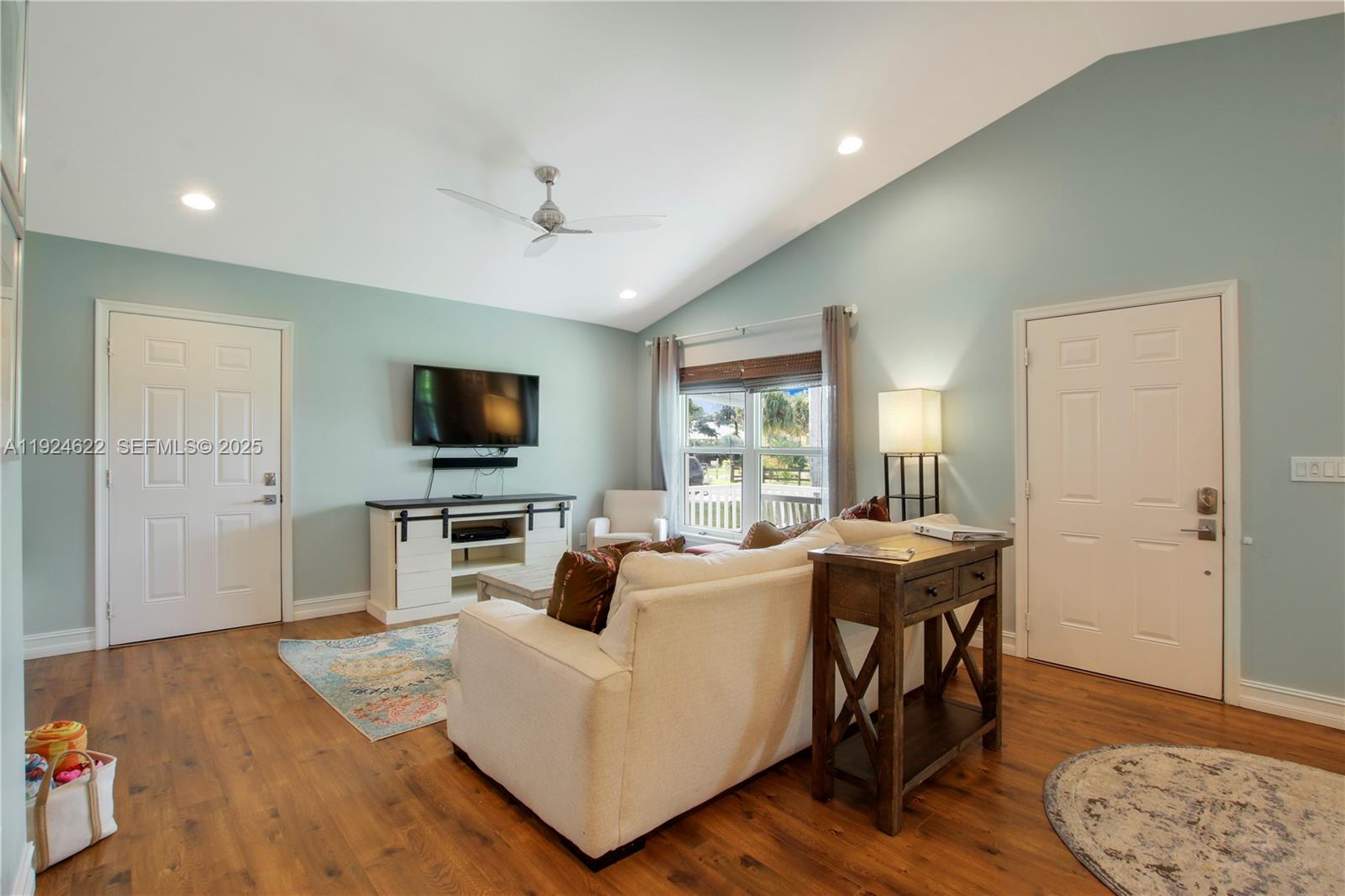 9155 Southeast Athena Street Hobe Sound, FL 33455 - Photo 4 of 25 a living room with furniture and a flat screen tv