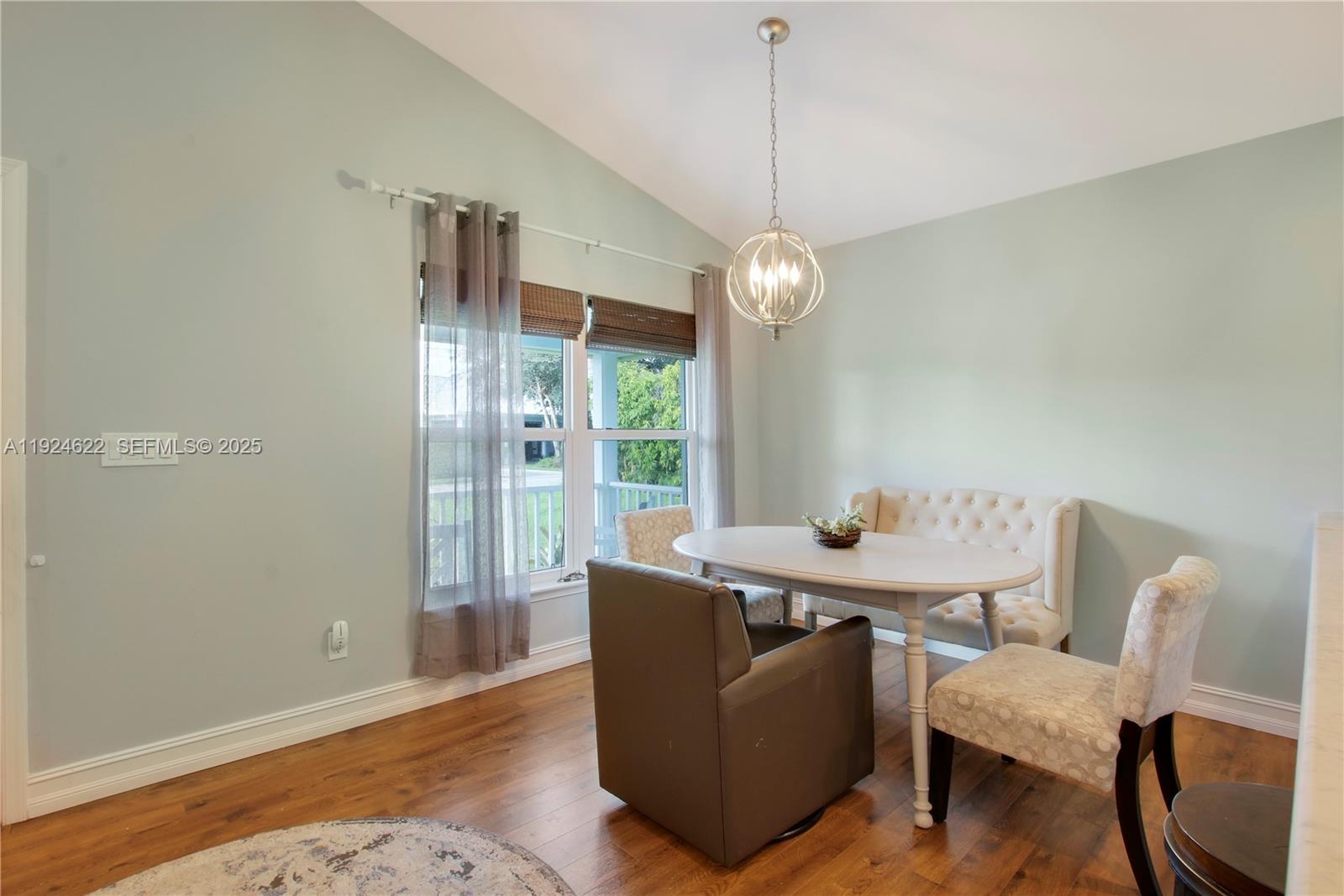 9155 Southeast Athena Street Hobe Sound, FL 33455 - Photo 7 of 25 a view of a dining room with furniture window and outside view
