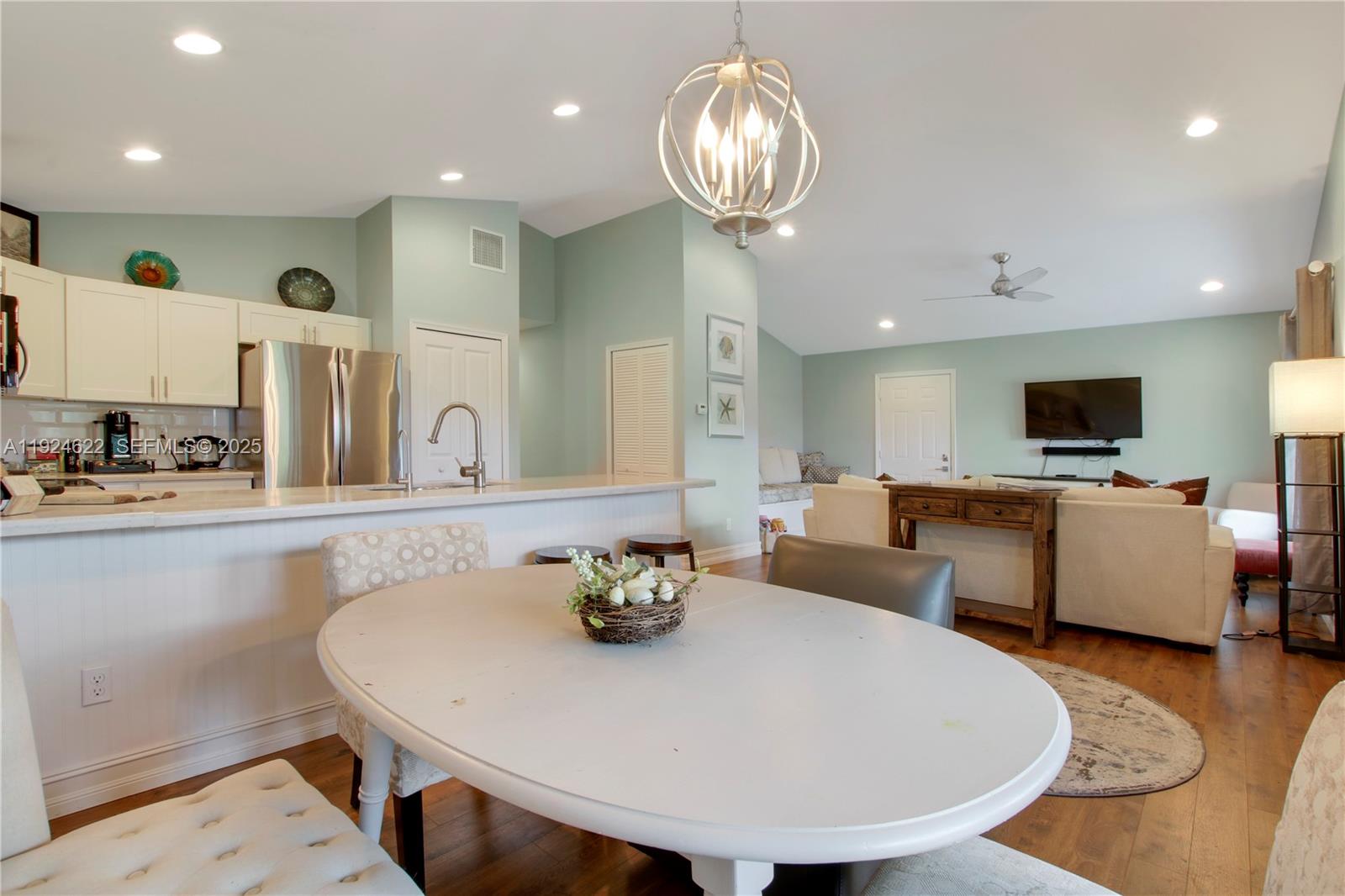 9155 Southeast Athena Street Hobe Sound, FL 33455 - Photo 8 of 25 a large kitchen with a table and chairs