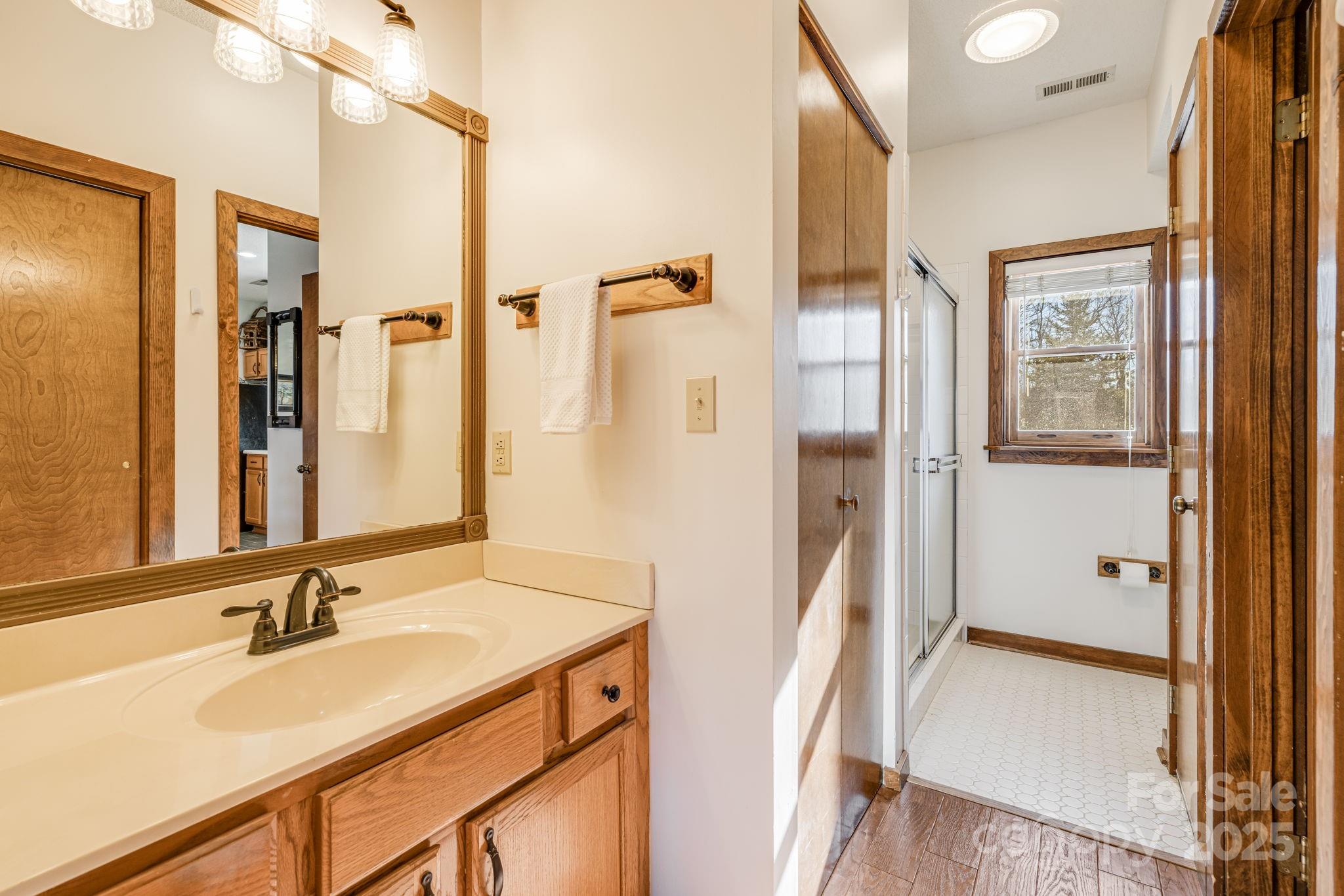 2521 Wolf Laurel Road, Unit 104 Mars Hill, NC 28754 - Photo 19 of 47 a bathroom with a sink a mirror and a shower