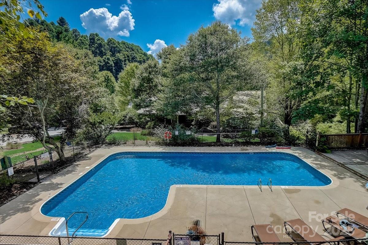 2521 Wolf Laurel Road, Unit 104 Mars Hill, NC 28754 - Photo 42 of 47 a view of backyard with swimming pool and outdoor seating