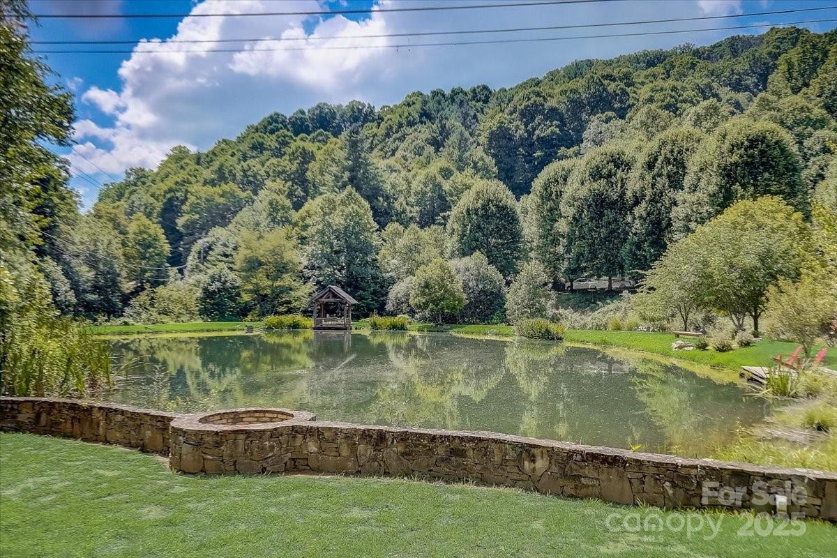2521 Wolf Laurel Road, Unit 104 Mars Hill, NC 28754 - Photo 44 of 47 a view of a lake with a yard