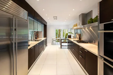 a kitchen with granite countertop a sink and cabinets