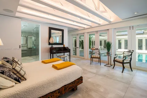 a large white kitchen with a large window and stainless steel appliances