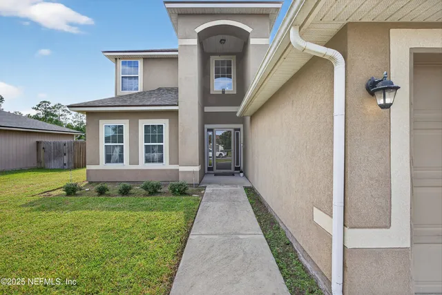an aerial view of a house with swimming pool and porch