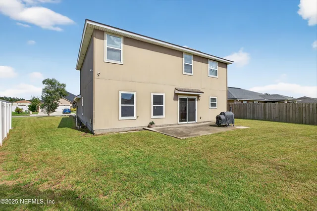 a living room with furniture a chandelier and a window