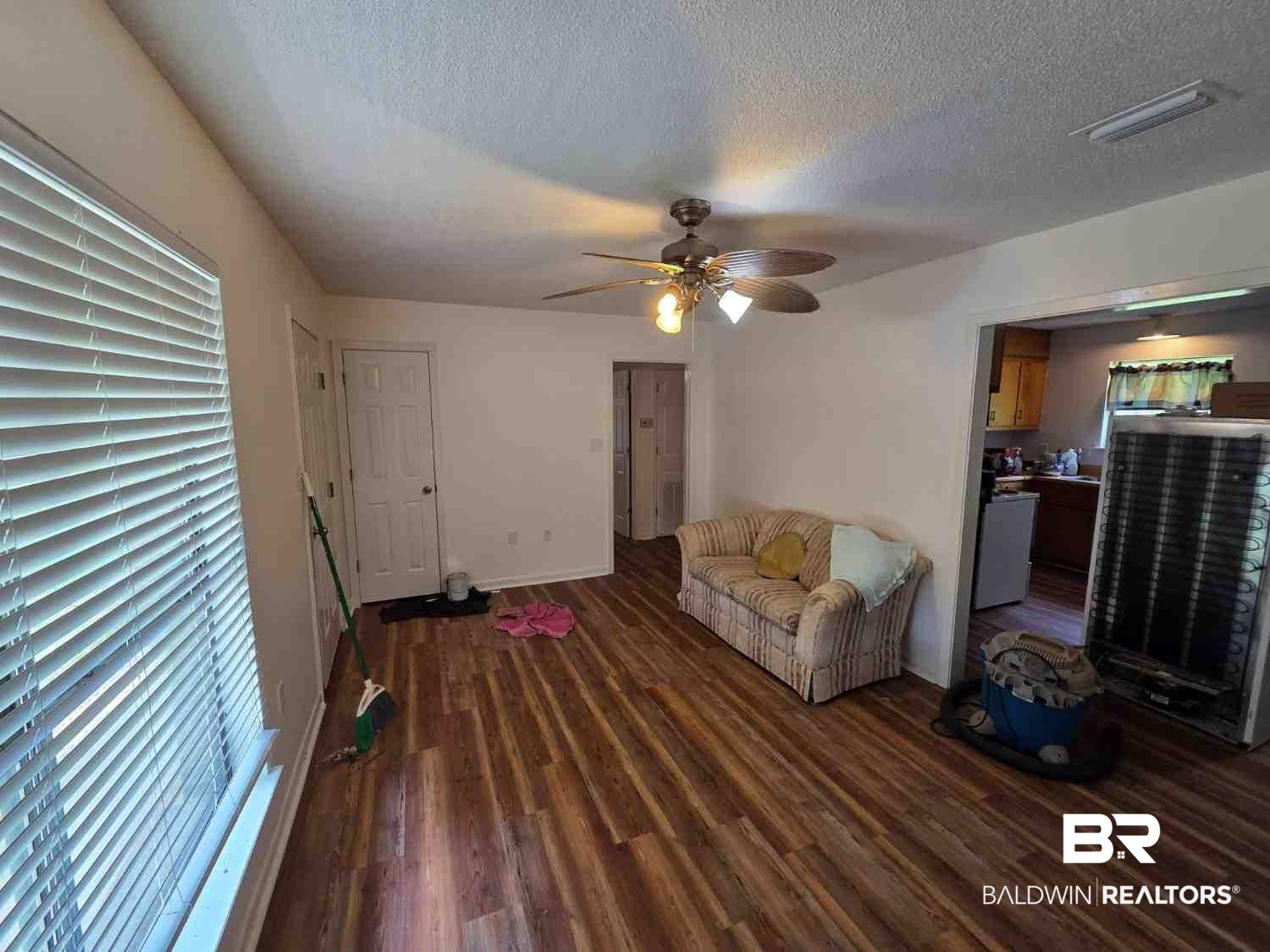 106 West 16th Street Bay Minette, AL 36507 - Photo 12 of 19 Living area featuring wood finished floors, ceiling fan, a textured ceiling, and baseboards