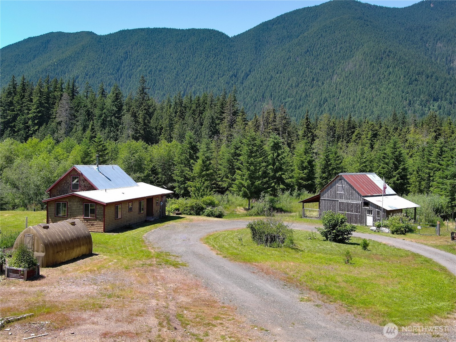 2904 Wildwood Road Quilcene, WA 98376 - Photo 1 of 39 an aerial view of a house with a garden