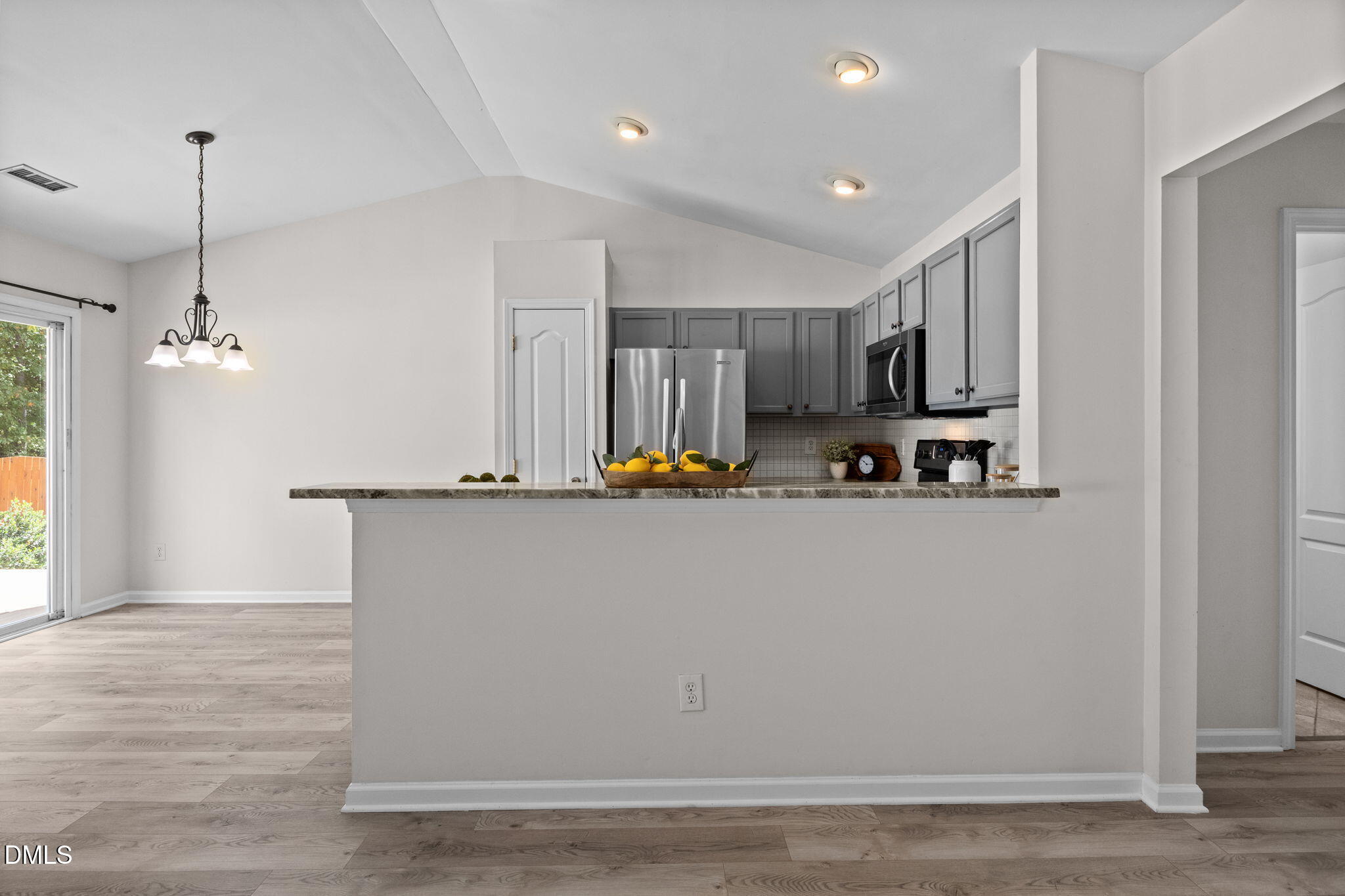 104 Saddle River Road Apex, NC 27502 - Photo 12 of 42 a view of a living room and kitchen with hardwood floor