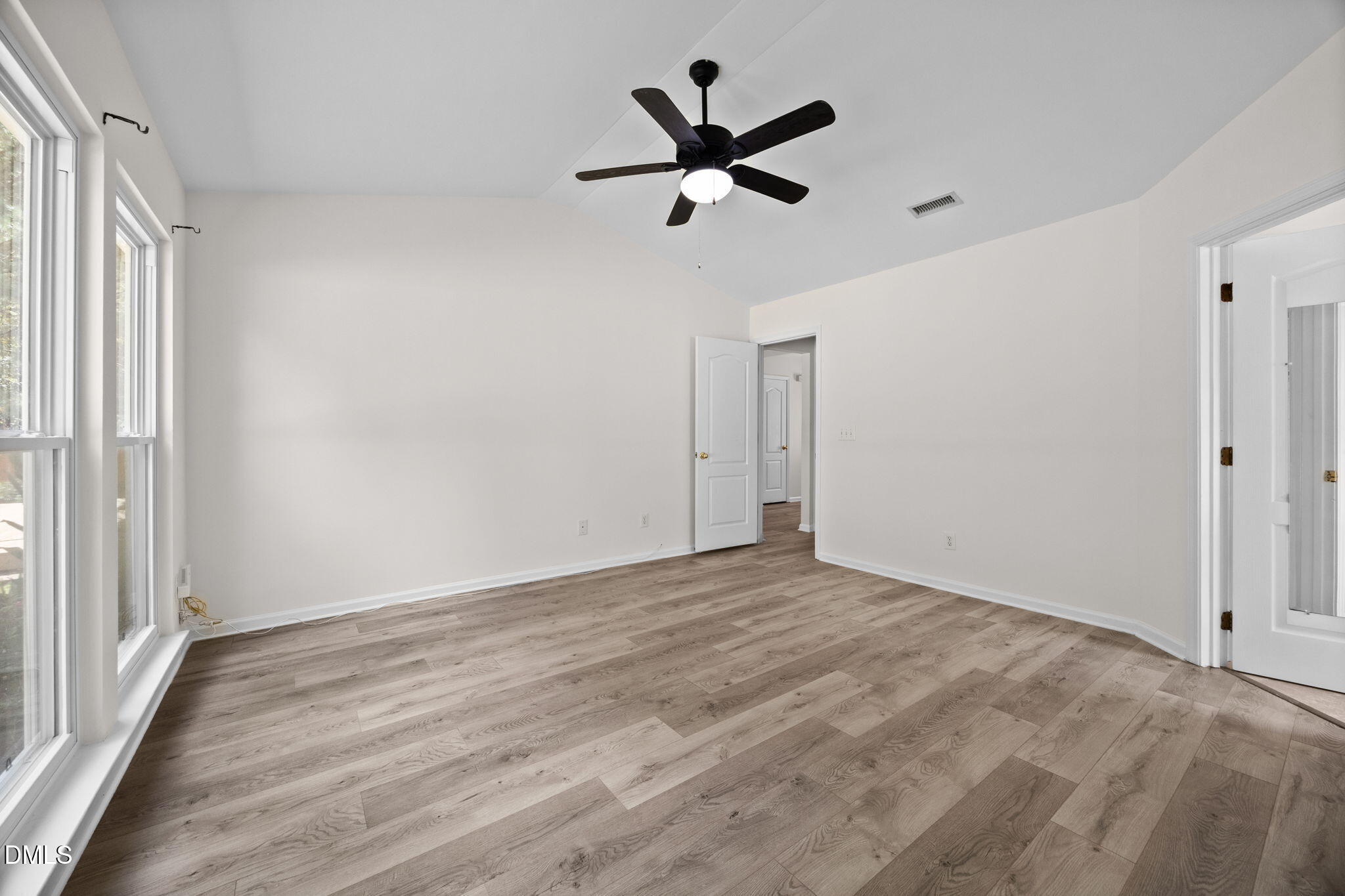 104 Saddle River Road Apex, NC 27502 - Photo 14 of 42 a view of empty room with wooden floor and ceiling fan