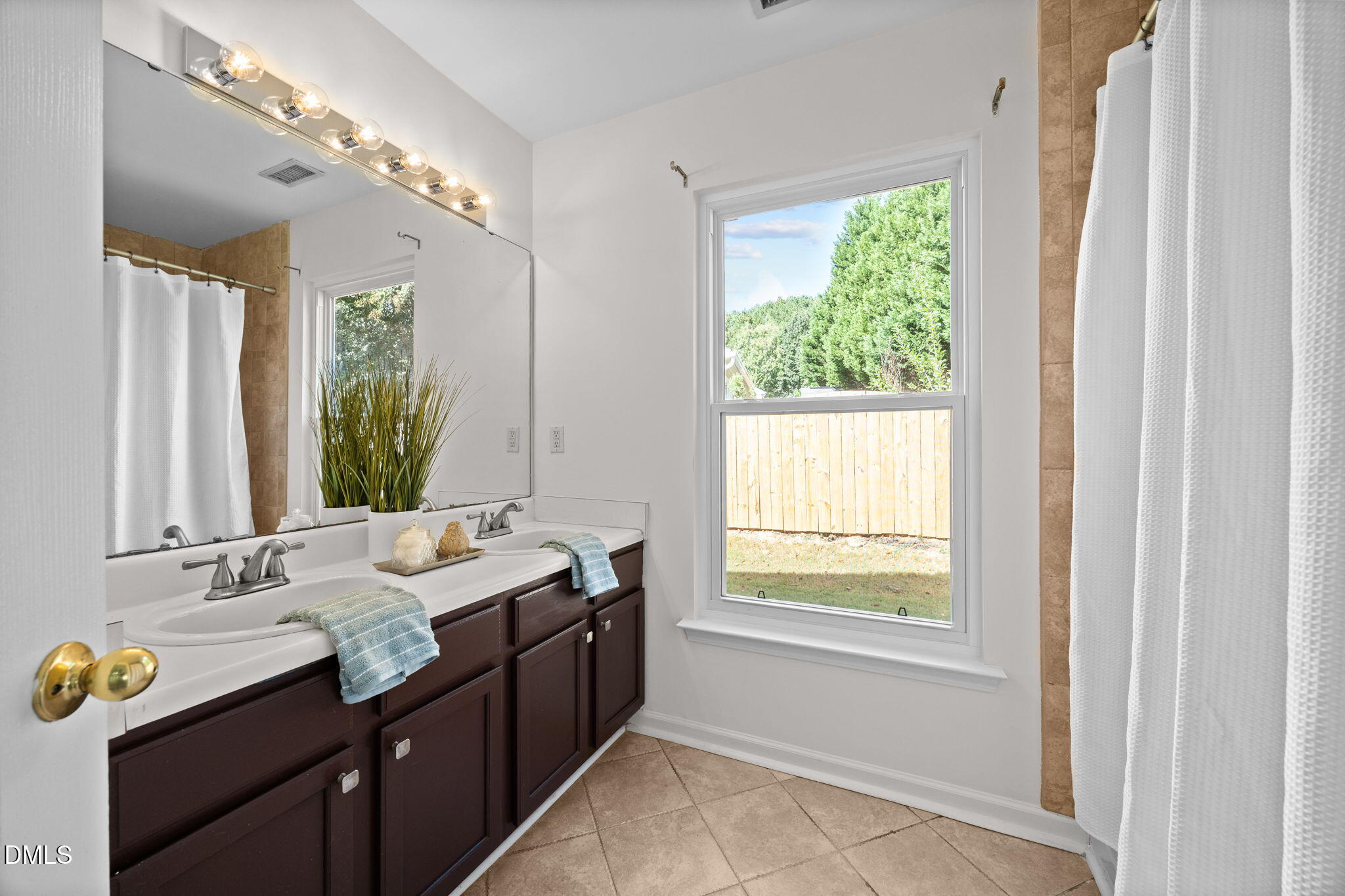 104 Saddle River Road Apex, NC 27502 - Photo 15 of 42 a bathroom with a granite countertop sink mirror and window
