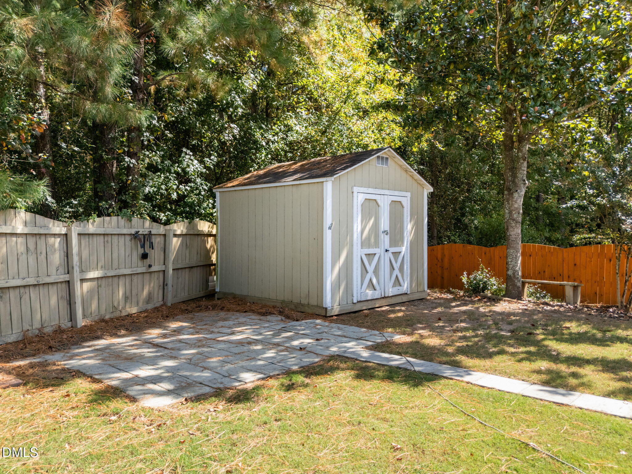 104 Saddle River Road Apex, NC 27502 - Photo 30 of 42 a view of a grey house with large trees and wooden fence