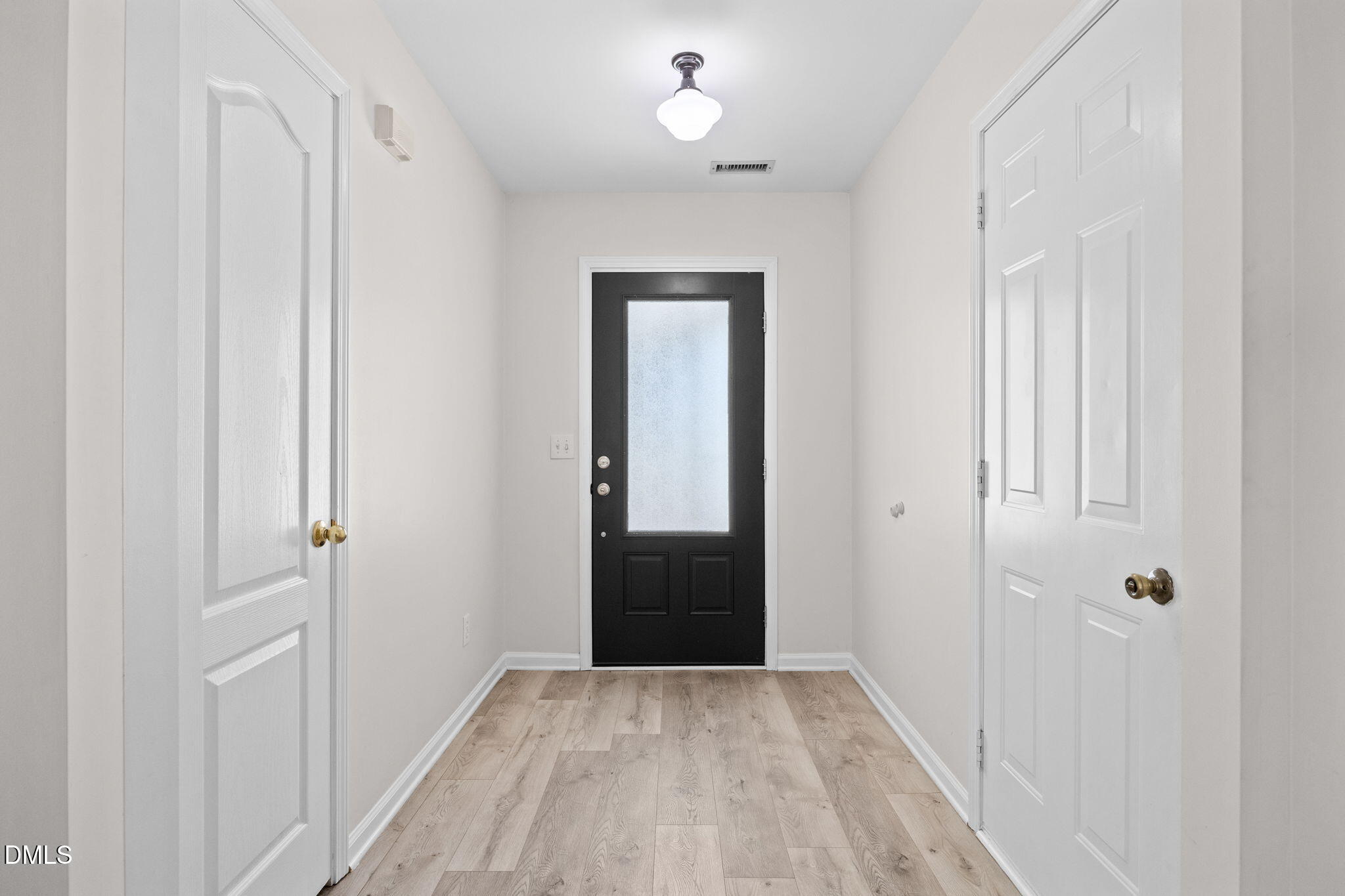 104 Saddle River Road Apex, NC 27502 - Photo 4 of 42 a view of a hallway with wooden floor and closet